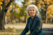 © smth.design - Mature Caucasian woman sitting on a park bench in autumn scenery