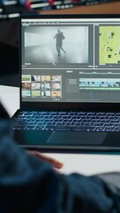 Poster - vertical video video editor trimming segments of drone shot footage, working on promotional clip in 