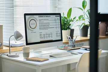Aufkleber - Graphic financial data on screen of desktop computer on workplace of financial analyst with cup of coffee, lamp and notepad
