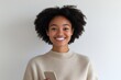 © khalid_spk - Portrait young woman natural afro hair beaming smile warm expression light beige sweater