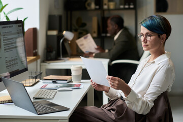 Aufkleber - Serious female analyst or economist studying fluctuations of interest rate on market while looking through financial data