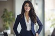 © khalid_spk - Professional woman navy blue pantsuit white top long dark hair bright smile office setting