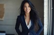 © khalid_spk - Professional woman navy blue pantsuit white top long dark hair bright smile office setting
