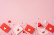 © ActionGP - Red and white envelopes with heart decorations on a pastel pink background evoke a romantic valentines day theme