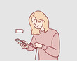 © autumnn - A woman plugs in her smartphone to charge it after noticing the red low battery indicator. Hand drawn style vector design illustrations.