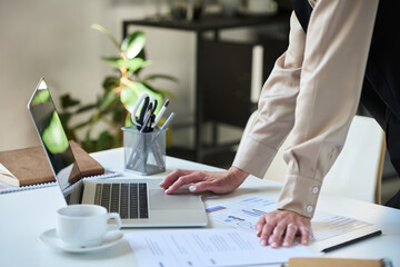 Aufkleber - Hands of young businesswoman in smart casualwear bending over desk and using laptop while analyzing online financial data