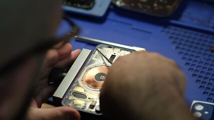 Poster - Smartphone repair in the service, replacement of the rear window. Phone repair in the service.Heats up the smartphone with a hairdryer. Battery Replacement