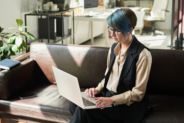 Aufkleber - Young female director of business company scrolling through online information in office while analyzing market