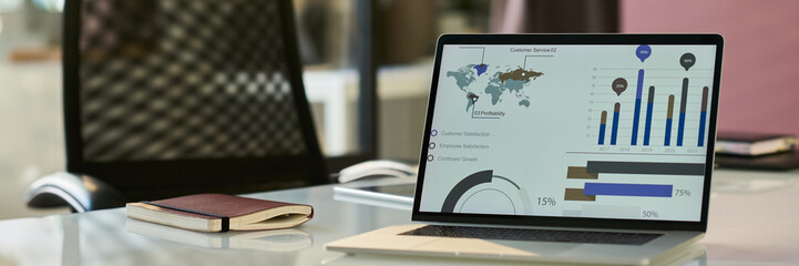 Aufkleber - Header of charts and diagram on screen of laptop standing on workplace of modern economist or other business specialist in office