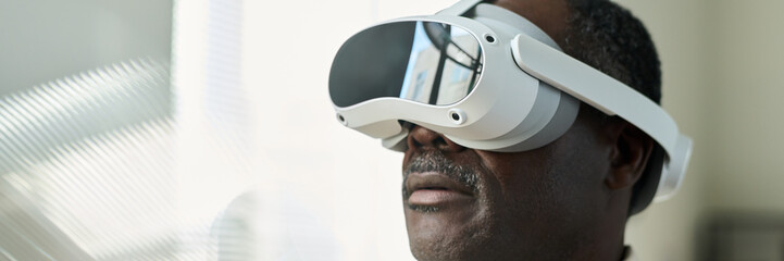Poster - Header of contemporary aged African American male broker wearing VR helmet watching presentation of financial data