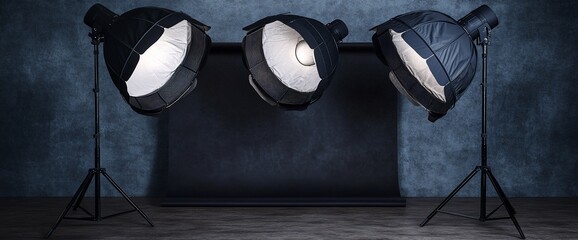 Poster - Three studio lights set up for photography against a textured backdrop.