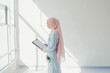 © Anna - Minimalistic Portrait of a Muslim Woman in Professional Attire by a Sunlit Window