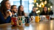 © Tobi - A team listening to their leader in a modern office with holiday-themed coffee mugs on the table