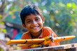 © Indian People Images - A young Indian boy invents games to play with his friends, his imagination turning everyday objects into tools for adventure and fun