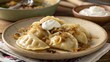 © Vera - Plate of traditional Polish pierogi with caramelized onions and sour cream.