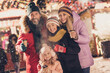© deagreez - Portrait of attractive cheerful family spending time life lifestyle visiting festal fair december eve sale city urban outdoors