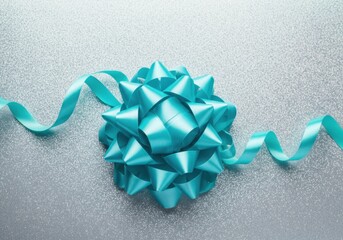 Wall Mural - elegant turquoise bow and ribbon on a sparkling silver background, adding a touch of festive charm