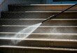 © Alexandra - Professional cleaning service is washing exterior stone stairs using high pressure water jet