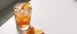 © Pixel Matrix - A refreshing cocktail is served on a table next to an orange wedge with a straw