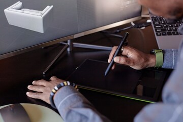 Leinwandbilder - Person using digital tablet and stylus for designing 3D model of furniture layout on computer screen, focusing on hand movements and technology in workspace