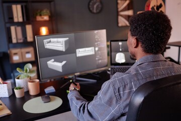 Leinwandbilder - Designer working on detailed virtual models of contemporary furniture in home office setup. Display shows 3D renderings of sofa, showcasing intricate design process