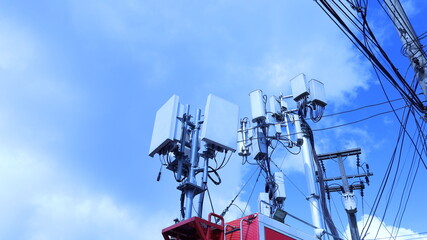 Wall Mural - Substation on the roof of the car. 4G and 5G telecommunication equipment mounted on car roof with power transmission lines on pole on sky background with copy space and selective focus