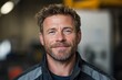 © c80 - A portrait of a cheerful bearded worker in a warehouse, wearing a jacket and posing confidently, exuding warmth and professionalism in an industrial environment.