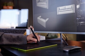 Leinwandbilder - Individual using graphic tablet for creating detailed 3D models in modern design studio. Computer screens displaying renders of sofa models in various perspectives