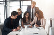 © peopleimages.com - Group, business people and tablet in meeting with teamwork, collaboration or coworking in office. Women, men and technology for brainstorming, discussion or review in project management as colleagues