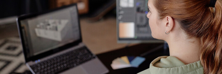 Leinwandbilder - Person diligently working on digital architectural models on dual computer monitors, showcasing detailed 3D design. Workstation setup includes multiple monitors and tools for design