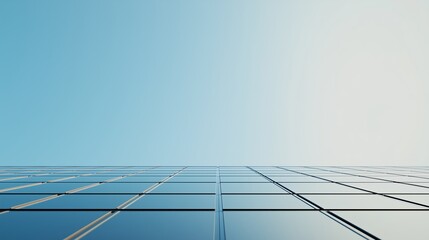 Poster - Skyward perspective of a modern glass building reflecting sunlight during a clear day with no clouds