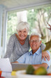 © peopleimages.com - Senior couple, tablet and documents for portrait with smile for profit, goal or investment growth in home. Elderly man, woman and paperwork with touchscreen, review or finance for retirement in Spain