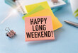 © Pawel - Happy Long Weekend text on notepad, concept blue background