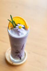 Wall Mural - Glass of blueberry smoothie with orange and rosemary