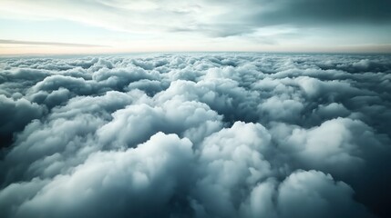 Wall Mural - Aerial view of thick, fluffy clouds in the sky, creating a serene and tranquil atmosphere in a vast open space under natural light conditions.