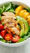 © Alla Bondaruk - Bright and colorful salad bowl with chicken, avocado, and cherry tomatoes captured in natural light