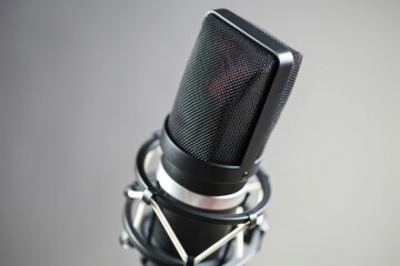 Poster - A close-up shot of a microphone on its stand, ready for use