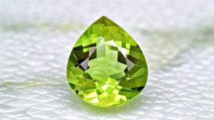 Poster - A close-up shot of a green gemstone on a white surface, suitable for jewelry or gemstone-related uses