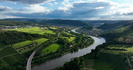 Wall Mural - Drone footage of Saar River and saarbrucken landscape with vineyards, green nature and dramatic sky