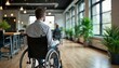 © miss irine - Man in wheelchair sits in modern office. People work at desks. Integration of people with disabilities in society shown. Accessible environment, workplace support emphasized. Modern interior design