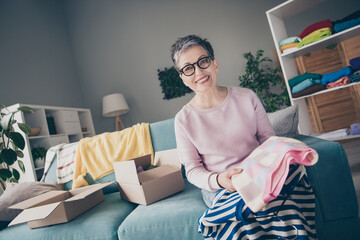 Wall Mural - Photo of good mood smiling woman dressed pink sweatshirt packing old outfits indoors house apartment room