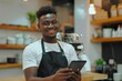 © Harsha - Young African entrepreneur in trendy cafe using digital tablet.
