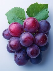 Wall Mural - A cluster of fresh grapes with droplets of water on a light background.