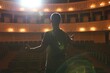 © New Africa - Professional actor rehearsing on stage in theatre, back view
