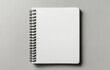 © ArtCookStudio - Blank spiral notebook on a light surface ready for sketches and notes