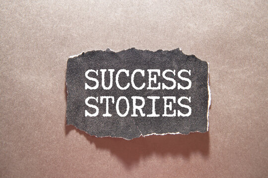 A hand holding a pink notebook with the text Success Story on a blue background.