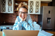 © Davor - Young woman working on laptop at home