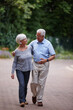 © peopleimages.com - Senior couple, hug and walking with support in neighborhood for bonding or retirement together. Elderly, man and woman strolling with care, embrace or love for commitment or morning chat in nature