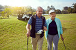 © ReeseFullyOwned/peopleimages.com - Golf, hobby and walking with senior couple outdoor on green course together for leisure activity. Grass, love and retirement with mature people playing sports for bonding or recreation in summer