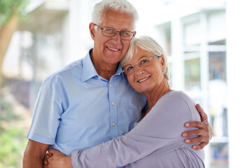 Canvas Print - Embrace, portrait and senior couple in apartment with love, care and happy marriage in retirement together. Hug, elderly man and old woman in home with smile, support and comfort in morning bonding.